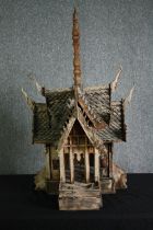 † A carved Thai spirit house from Chiang Mai. H.100 W.62 D.53cm.