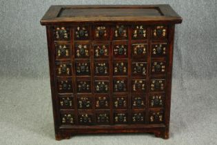 † A Chinese hardwood apothecary chest. H.80 W.80 D.44cm.