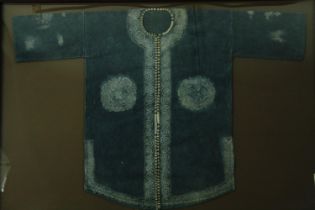 † Tribal tunic with batik design, framed and glazed. H.113 W.163cm.