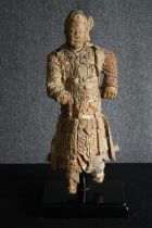 † A 19th century Chinese carved figure of a Chinese warrior in traditional robes. H.66cm.