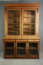 A Victorian walnut library bookcase with glazed doors. (In two main sections). H.233 W.161 D.50cm.