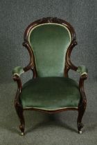 A late Victorian carved walnut open armchair. H.95cm.