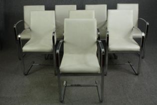 A set of eight contemporary white faux leather and chrome framed dining chairs.