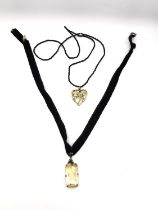 Two early 20th century French necklaces one with a rolled gold pendant in the form of a heart with a