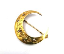 An antique French 18ct yellow gold rose cut diamond set crescent moon brooch, set with seven rose