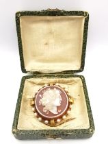 A boxed 19th century French yellow metal (tests as 18ct) mounted carnelian cameo pendant brooch,