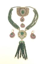An Indian silver synthetic emerald and ruby five piece jewellery set consisting of a cuff bangle,