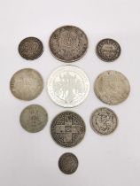 A collection of ten white metal coins, including a silver proof Alderney two pound commemorative