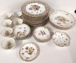 A group of various hand painted and gilded Dresden porcelain wares with floral decoration.