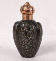 A 19th century Japanese hammered white metal and yellow metal lobed form scent bottle with relief