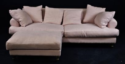 A pink upholstered sofa.com three-seater sofa and matching footstool. H.80 W.250 D.110cm.