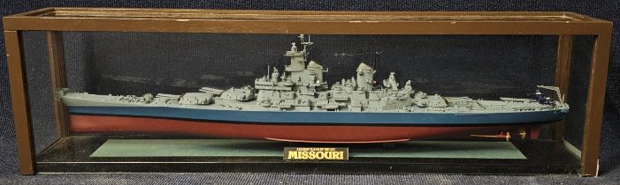 A ship's model of the US Battleship Missouri, in a perspex show case