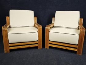 A pair of Art Deco style teak garden or conservatory easy chairs, with piped white upholstery. H.