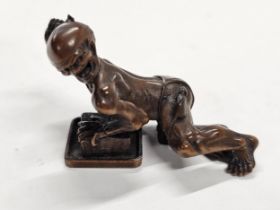 A Meji period Japanese wood netsuke of a thwarted rat catcher. Carved as a rat catcher grimacing