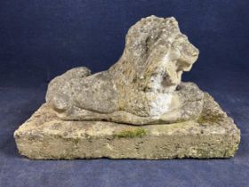 A weathered composition stone lion figure on a concrete base. H.60 (Base W.95 D.47cm.)