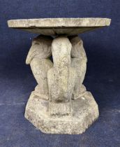 A weathered composition stone garden table. H.49 W.48cm. (Breaks down in to five sections).