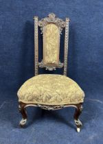 A late Victorian carved walnut prie dieu chair.