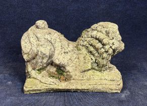 A weathered composition stone garden statue, Eastern stylised lion. H.40 W.54 D.25cm.