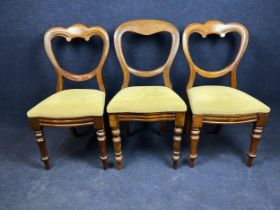 A pair of Victorian walnut balloon back dining chairs, and another similar.