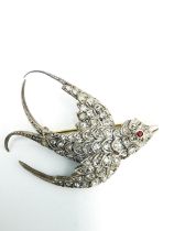 A Victorian pink metal (tests as 9ct gold) and silver rose cut diamond set swallow brooch, set