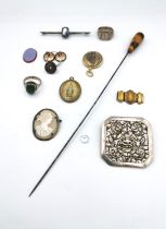 A collection of mixed costume jewellery, including a tigers eye hat pin, a white metal (tests as