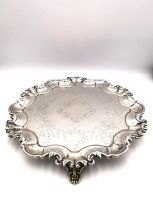 A Victorian silver three footed mint/card tray with engraved scrolling design and scrolling