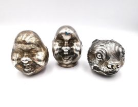 Three early 20th century Japanese white metal (tests as silver) heads, two laughing buddhas one with
