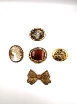 A collection of five Victorian rolled gold and yellow metal brooches, including a yellow metal