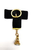 A Victorian 18ct carved gold fob seal with polished bloodstone plaque mounted on black velvet ribbon