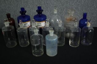 A group of vintage apothecary bottles, including Bristol blue examples. H.26cm. (largest).