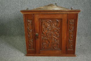 A 17th century style carved oak hanging corner cabinet, early 20th century. H.67 W.72 D.35cm.