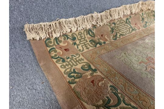 A large woollen carpet with allover Chinese motifs on a taupe field within stylised borders, - Image 4 of 6