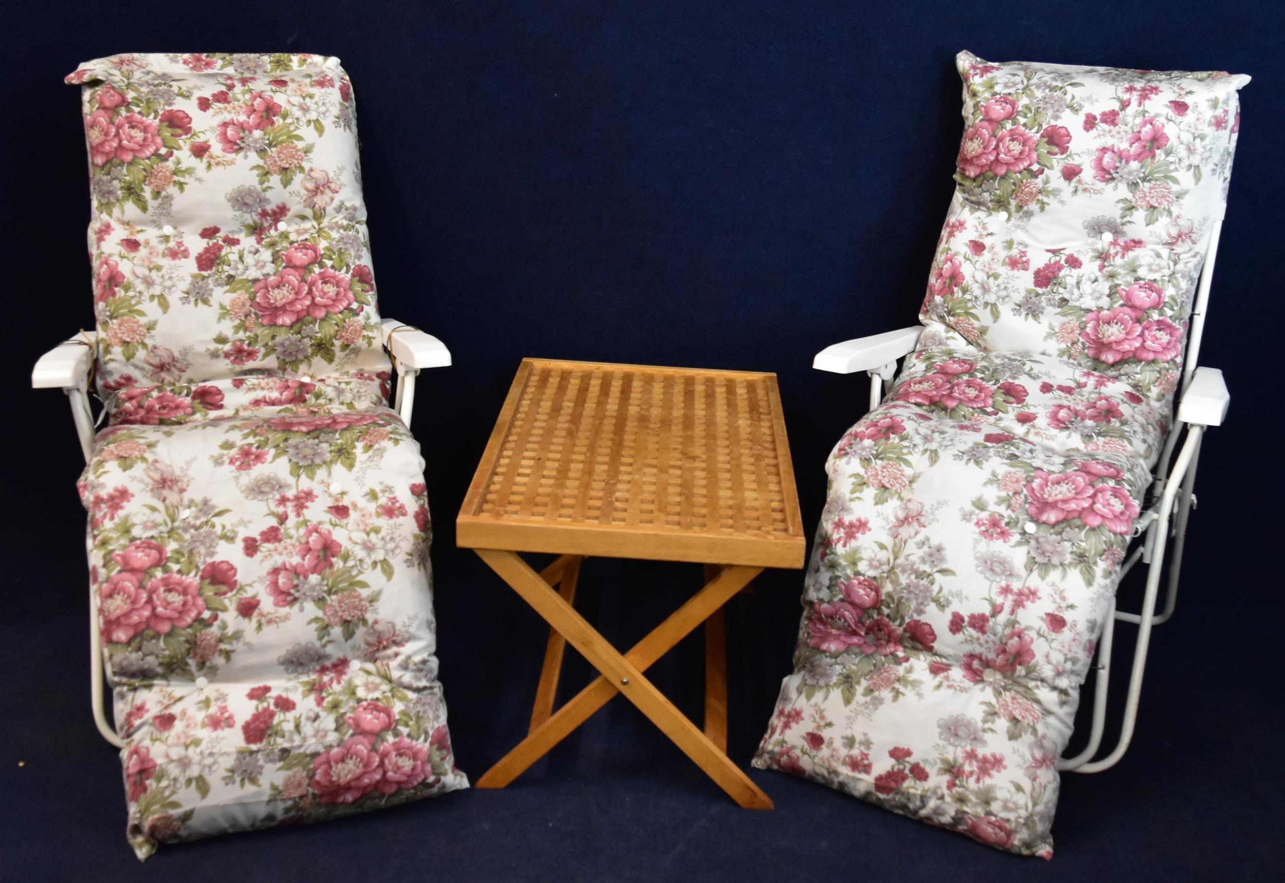 A pair of garden reclining chairs and a folding garden table