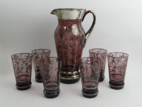 Venitian amethyst glass water jug and six glasses with silver overlay decoration, jug 29.5cm.