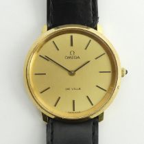 Omega De Ville gold tone manual wind watch on a black leather strap, 35.3mm inc. button. Condition