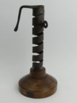 19th Century iron and wood spiral courting candle holder on a later base, 22cm.