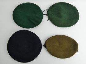 Four military berets inc. one World War II blue example.