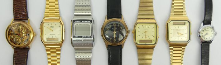 A box of various old watches including visible movement examples.