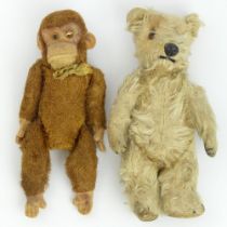 A Schuco type monkey and an old mohair teddy bear. 22cm and 23cm.