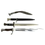 Three bayonets including a short German bayonet along with a World War II Kukri, longest 50cm.