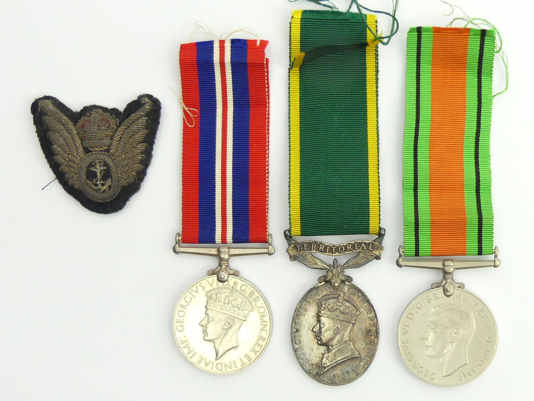 World War II medal group including Territorial for Efficient Service and a cloth badge, issued to