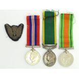 World War II medal group including Territorial for Efficient Service and a cloth badge, issued to