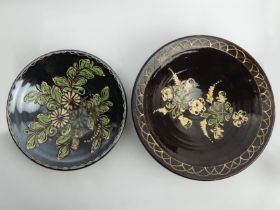 Two continental floral slip-ware pottery bowls C.1900, largest 33.5cm x 10cm.