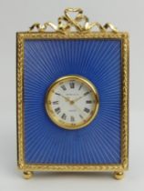 Kitney & Co enamel and gilt metal easel back mantel clock in a fitted case, 11cm.