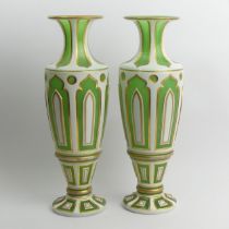 A pair of 19th Century Bohemian Uranium green and white overlaid glass vases with gilt, 37cm.