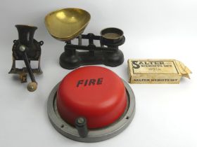 A set of brass and iron scales and weights along with a fire bell and an old mincer.