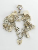 Sterling silver charm bracelet, 74.9 grams.