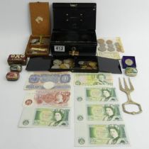 An old money box and contents including H.M.V. needle tins and old money.