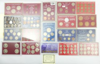 Nineteen cased coin sets, mostly UK Elizabeth II examples.