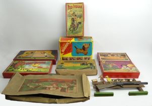 A box of old toy games, including Fight for the Cup and a battery operated toy Dachshund.